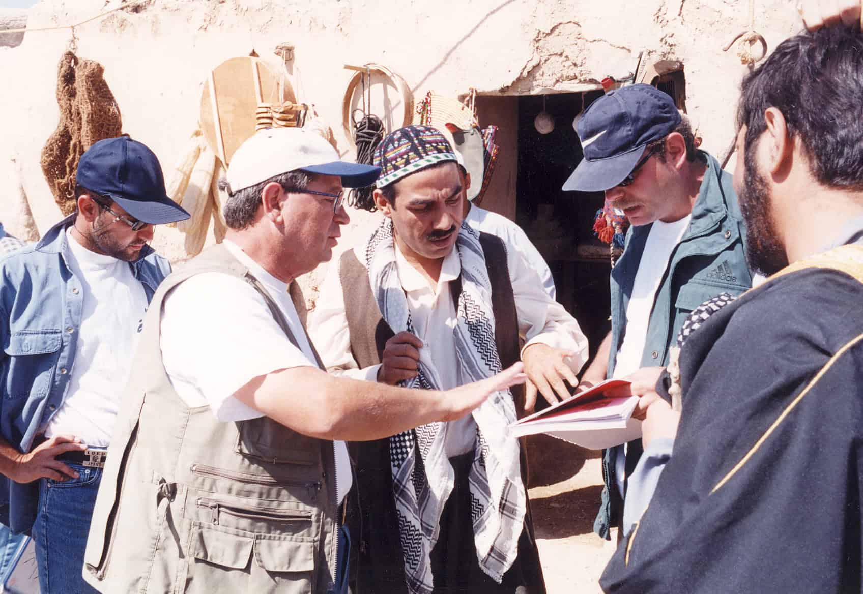 Filmmakers discussing scene details on set during The Rebel Days production.