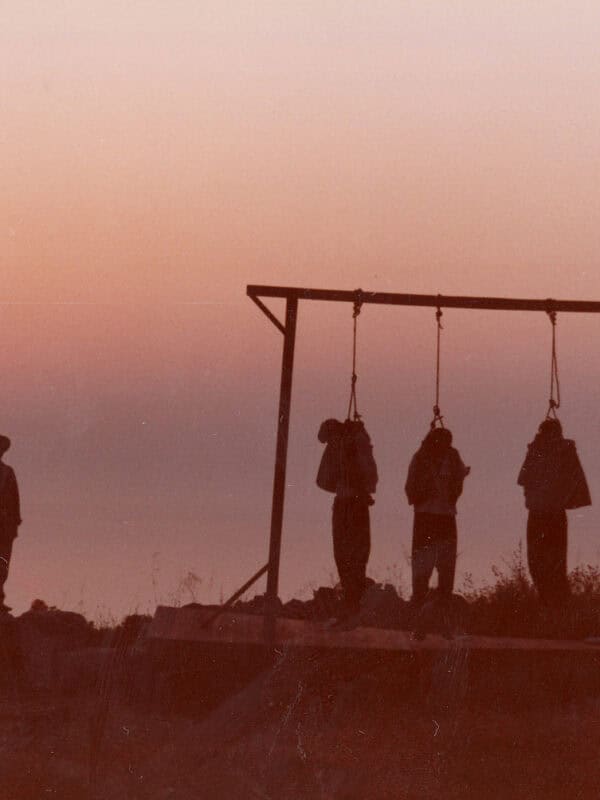 Silhouette of a person watching three swings at sunset, symbolizing resilience.